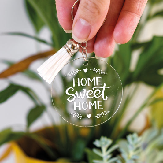Clear round keyring with 'Home Sweet Home' text and a tassle, perfect for a small gift.