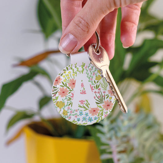 Keychain with colourful floral design and white monogram made from high-quality white faux leather and scratch-resistant print.