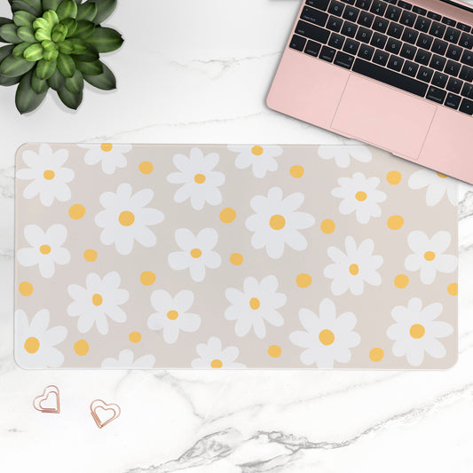 Floral desk mat with daisies on a desk with a laptop and plant