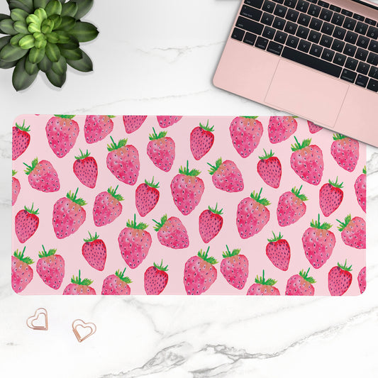 Strawberry patterned Desk Mat on a desk with a laptop and plant.