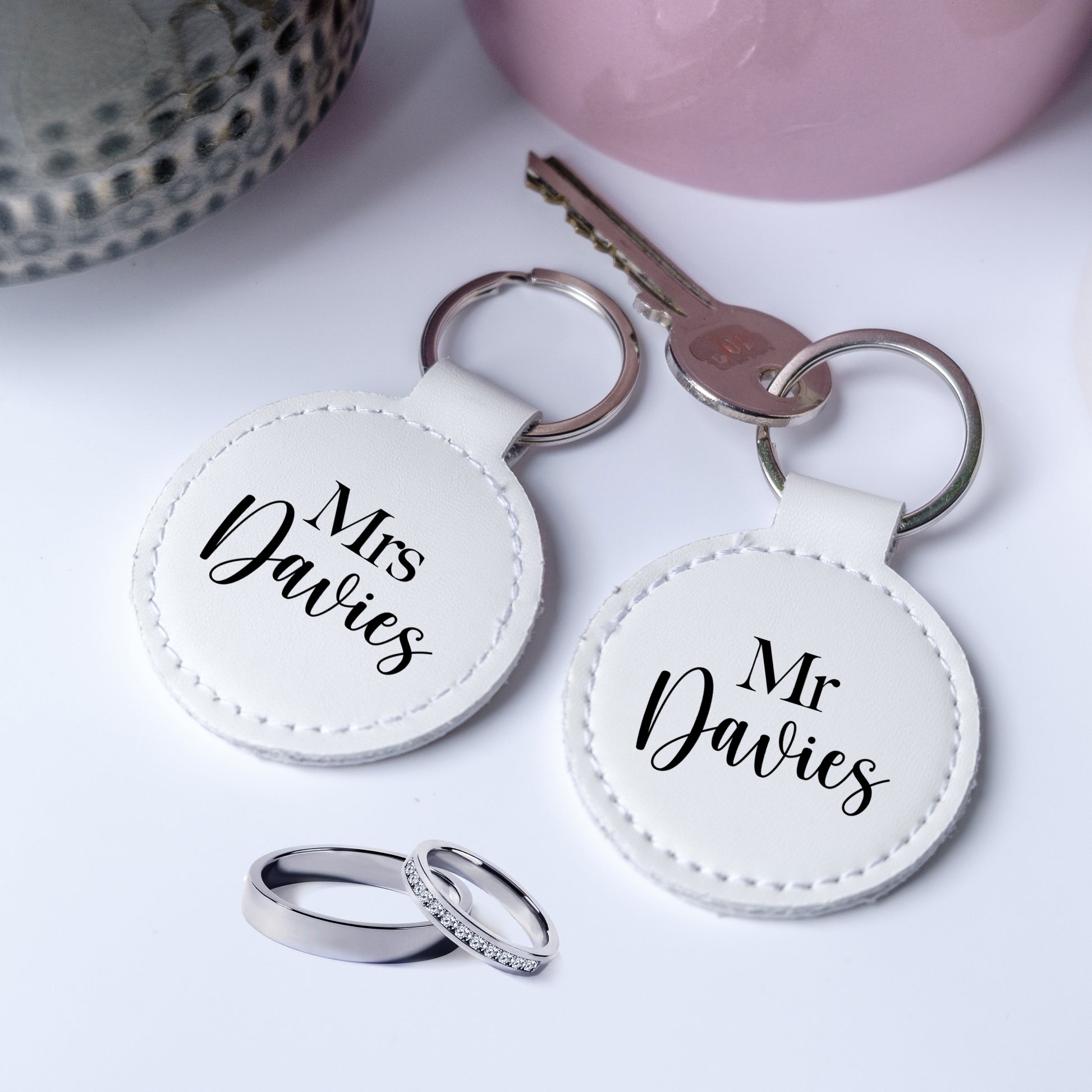 A set of two leather keyrings with black writing Mr and Mrs, personalised with the family name, perfect gift for newelyweds.