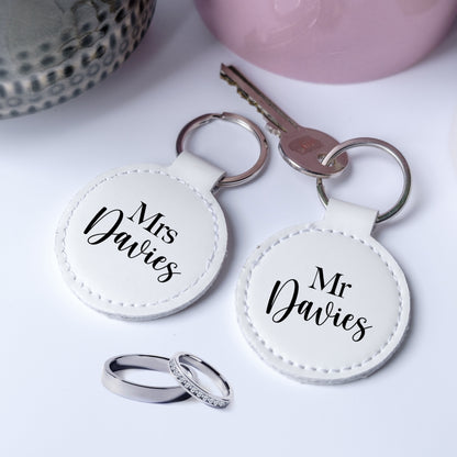 A set of two leather keyrings with black writing Mr and Mrs, personalised with the family name, perfect gift for newelyweds.