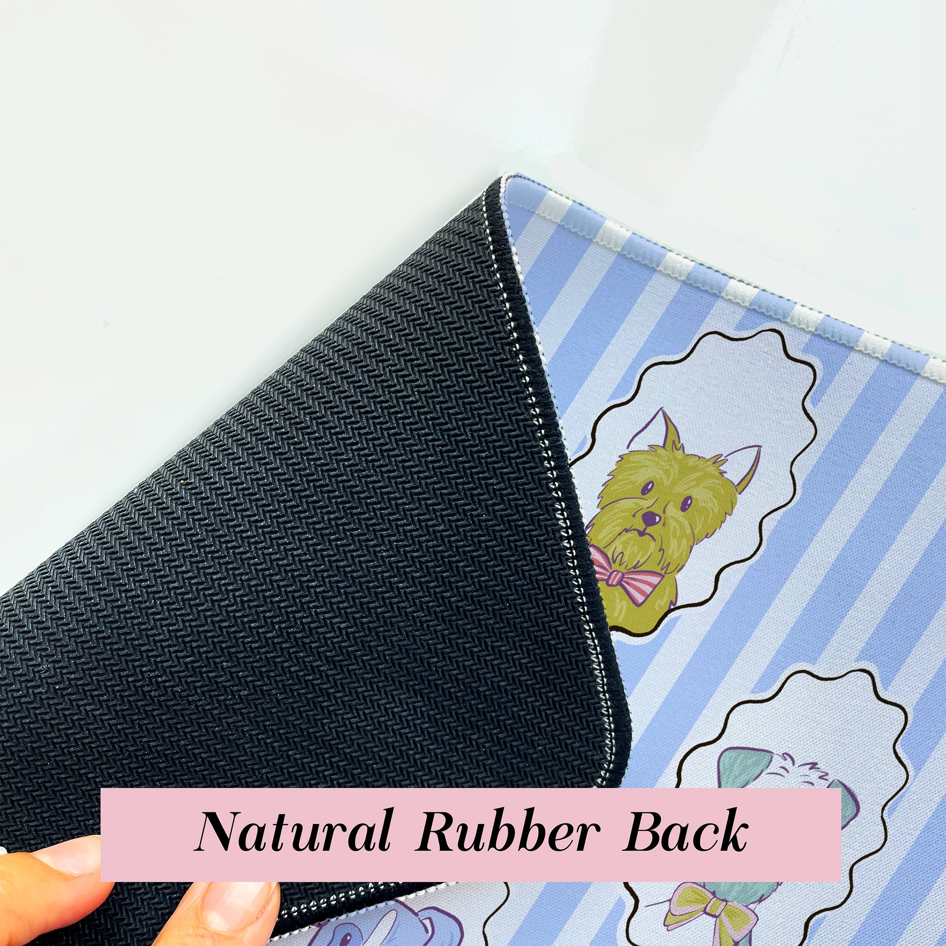 Close-up of blue dog striped desk mat with rubber back