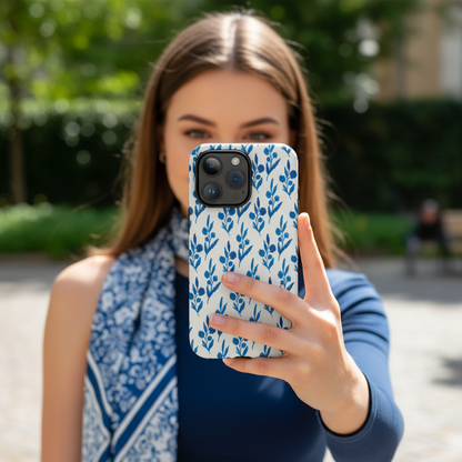Woman holding a phone with the blue florals phone case showing it in real life setting