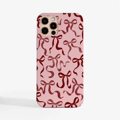 Cuteand elegant Christmas phone case with pretty ribbon design on a soft pink background. 
