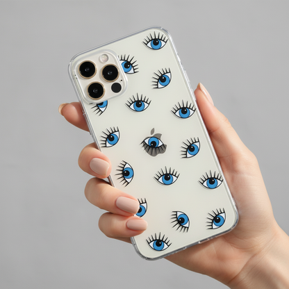 woman's hand holding a phone with a clear evil eye phone case