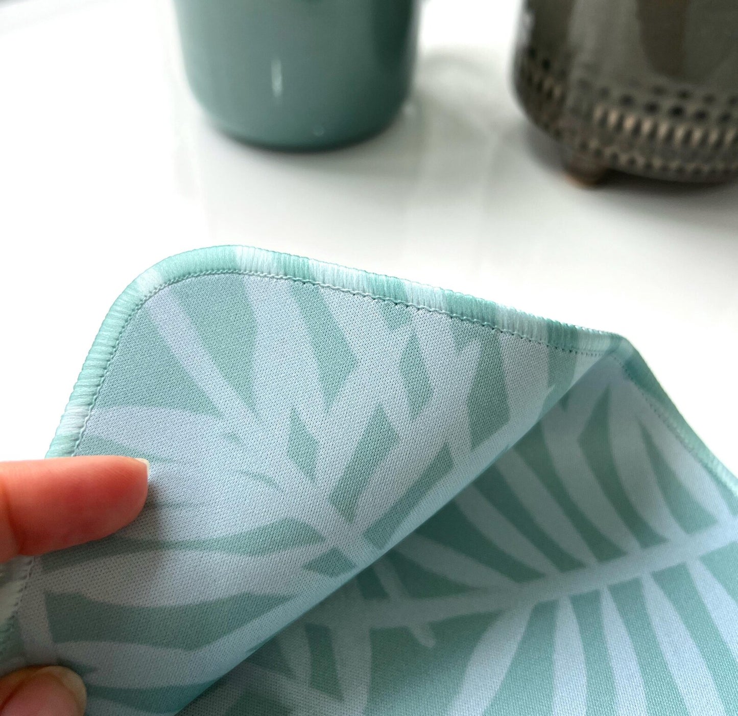 Close up shot showing stutched edges on the Green Botanical Desk Mat