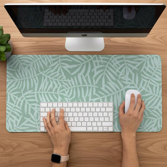 Person working on a desk with a Green Botanical Desk Mat