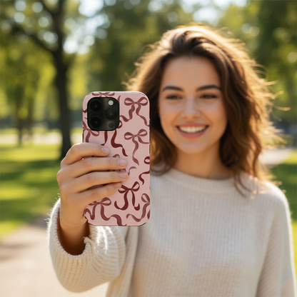woman taking a selfie with the pink bow phone case showing everyday use