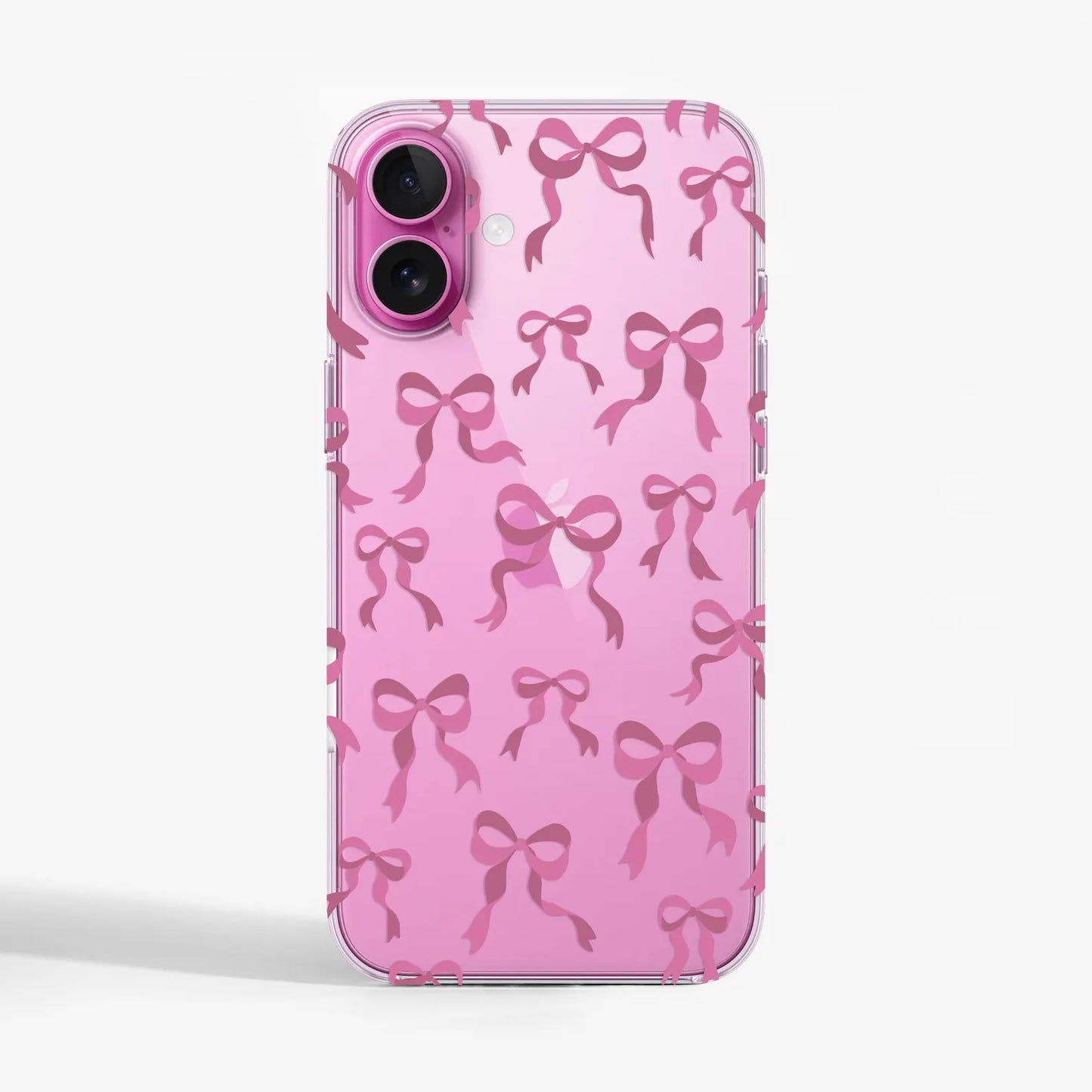 Clear phone case with pink ribbon bow print on a pink iPhone16e with transparent sides. 