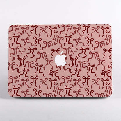 Aesthetic Ribbon Bows MacBook Case with pink hand-painted ribbon design. Cute and protective laptop cover that adds personality to your workspace.