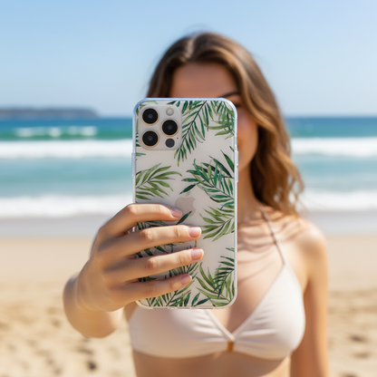 Woman talikng a selfie with a phone with clear tropical leaves phone case.