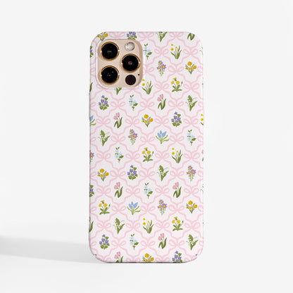 Tough phone case with a vintage wildflower pattern and soft pink bow lattice for feminine floral aesthetic