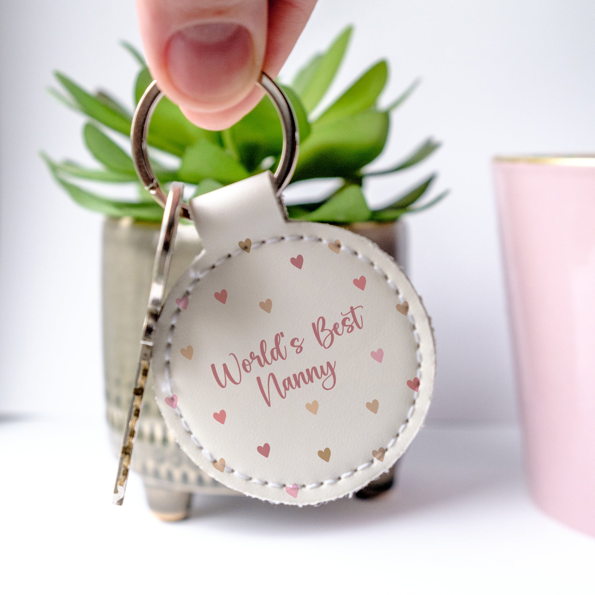 Cute leather keyring with a sweet message - Worl'd Best Nanny, and hearts in soft dakr pinks
