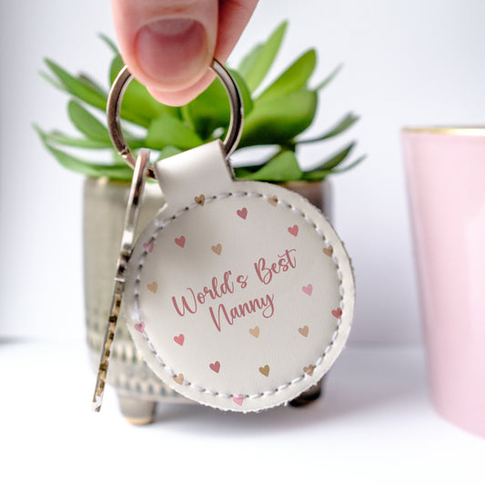 Cute leather keyring with a sweet message - Worl'd Best Nanny, and hearts in soft dakr pinks