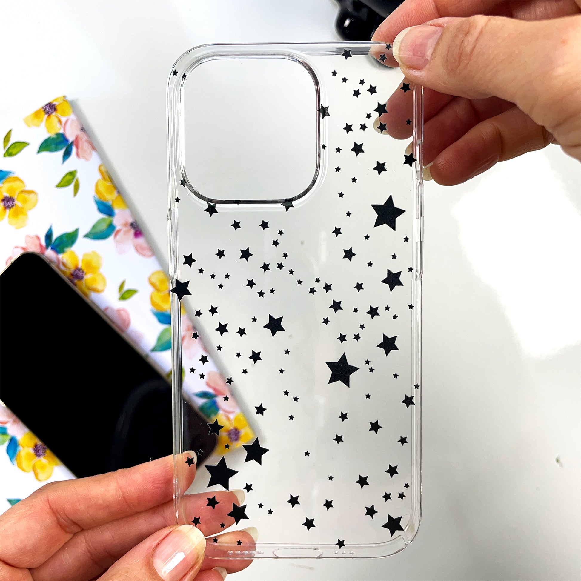 woman hodling stars phone case shwoing it in real life