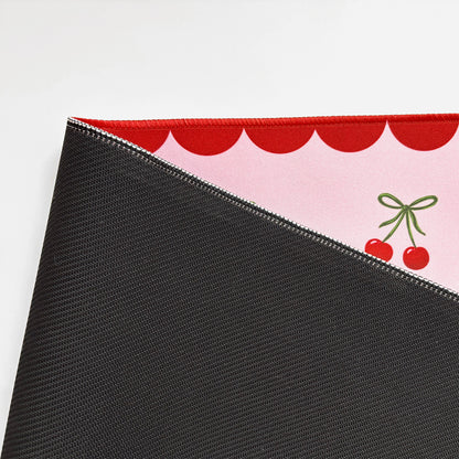 Close-up of the Cute cherry desk matshowing non-slip run=bber base and stitched edges