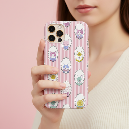 A close-up of a person holding a smartphone with a pink phone case featuring cute pastel cartoon cats in white cloud-like frames over pink vertical stripes.