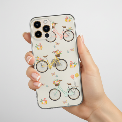 Phone case with bicycle and floral design held by a hand