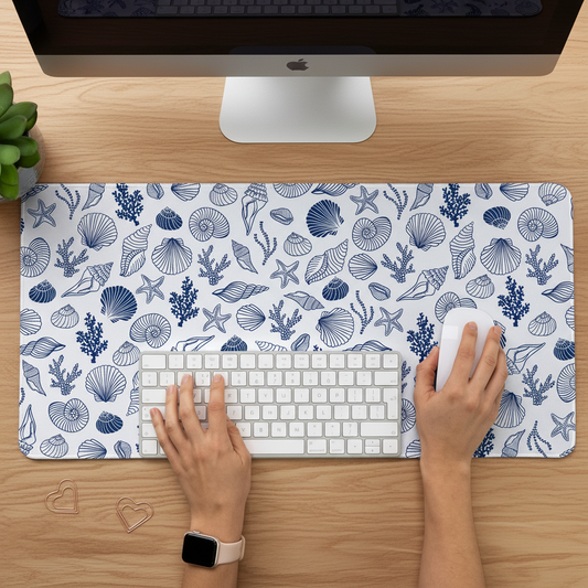 person working on a desk with Coastal Desk Mat featuring outlised blue sea shells for an aesthetic setup