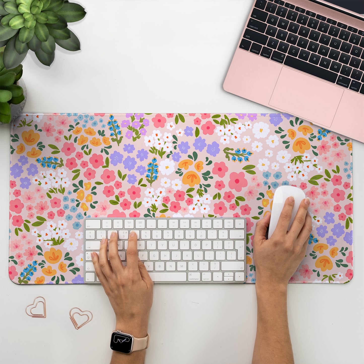 Pretty floral desk mat with colourful flowers on a soft pink background, perfect for a cosy and easthetic desk setup