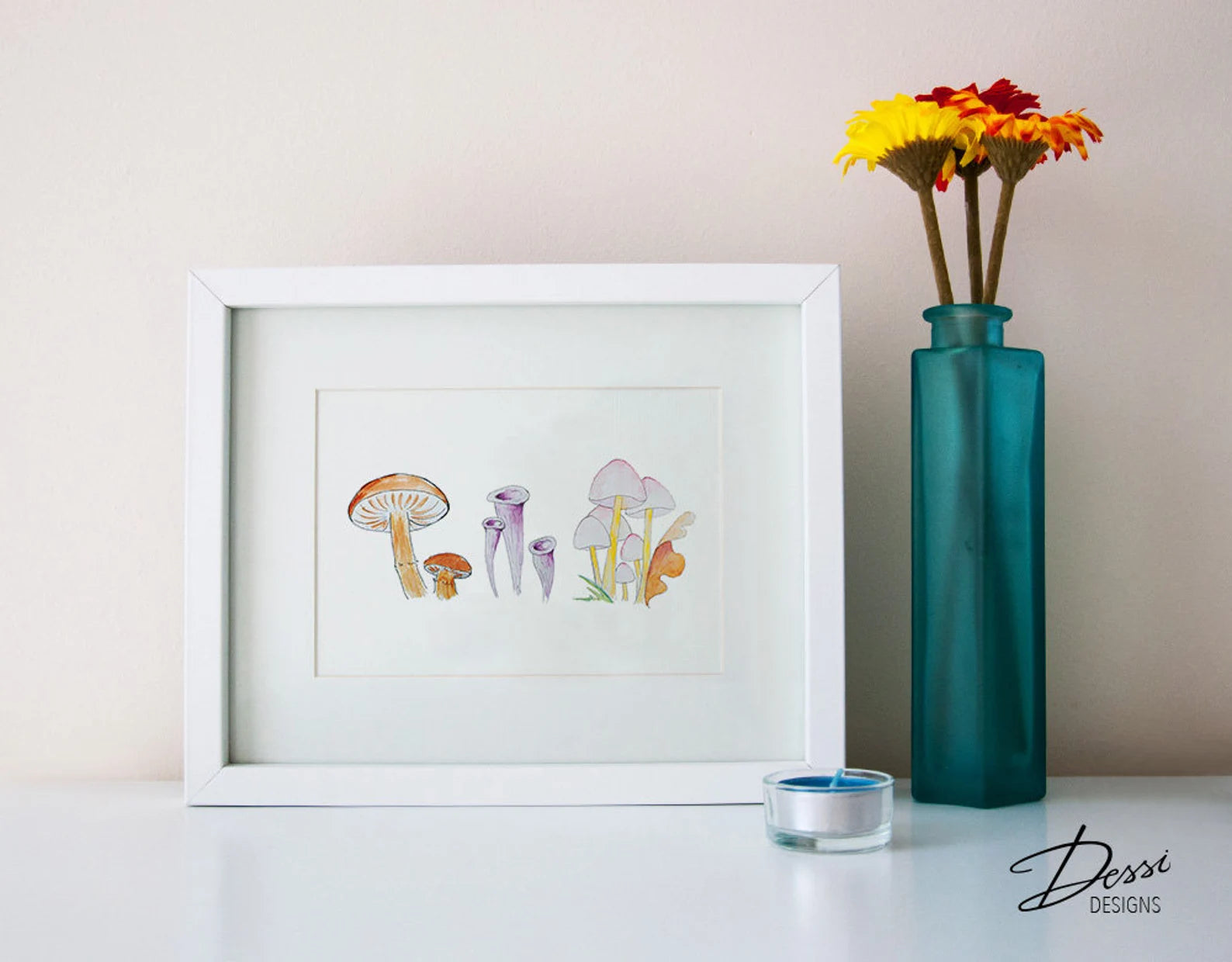 Framed artwork of mushrooms on a table with a teal vase and flowers.
