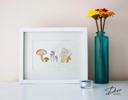 Framed artwork of mushrooms on a table with a teal vase and flowers.