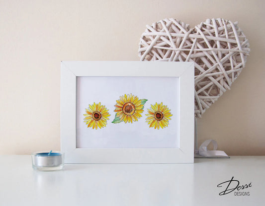 Framed artwork of sunflowers on a table with decorative heart and candle.