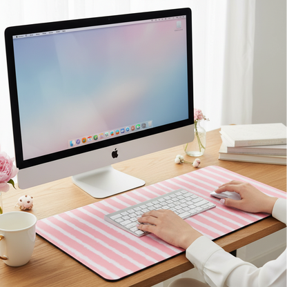 Desk setup with the pink stripes desk mat offering comfort and stability