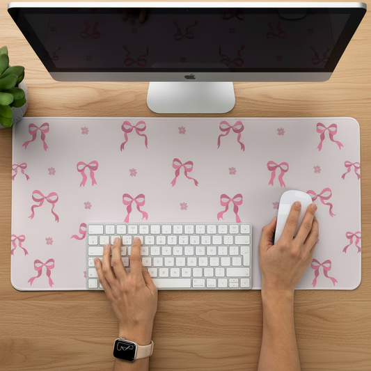 pink desk mat featuring ribbon bows and small flowers in everyday use