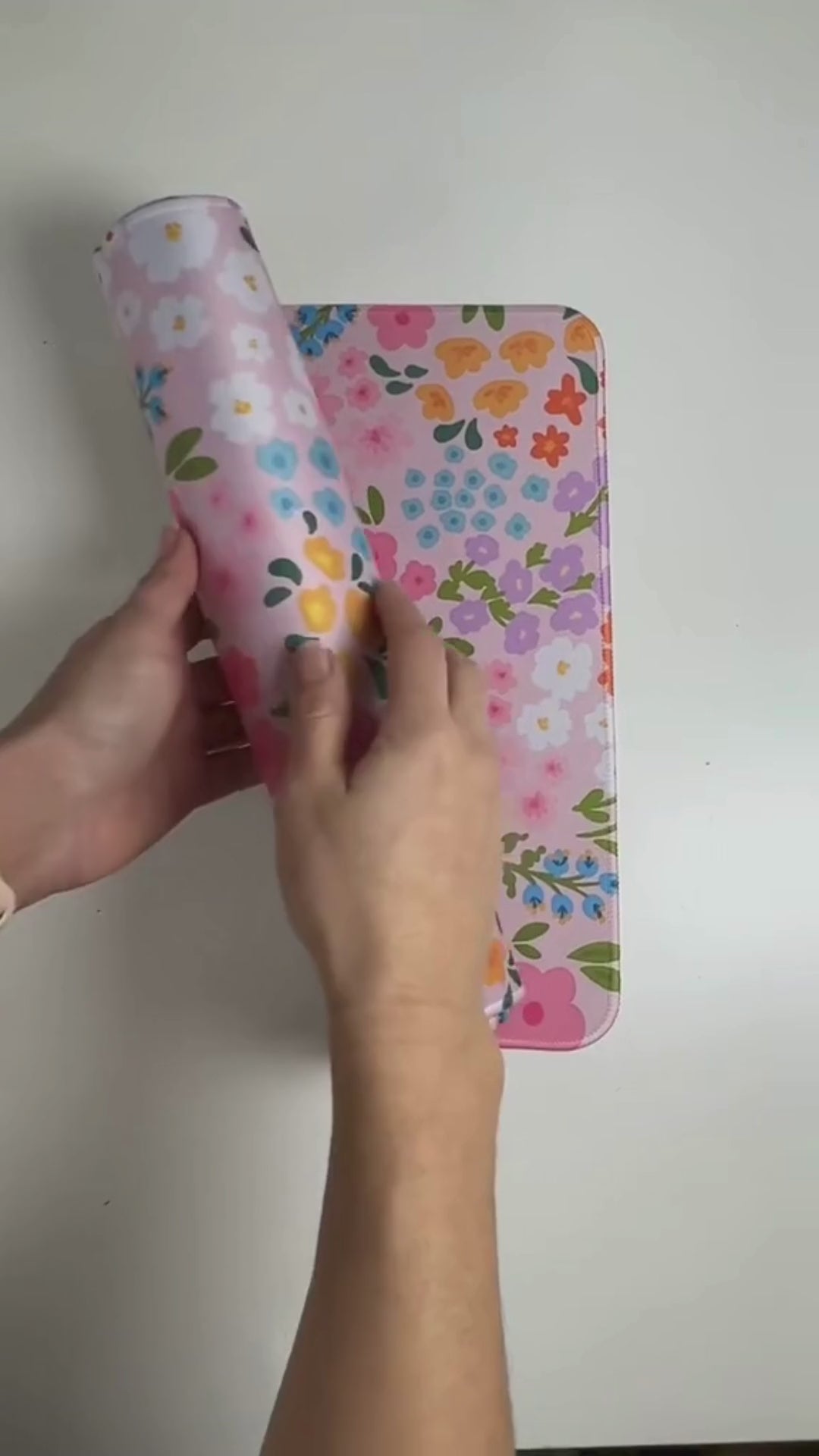 Video showing  large floral desk mat with cute colourful print, smooth surface, stitched edges and rubber base for an aesthetic desk setup.