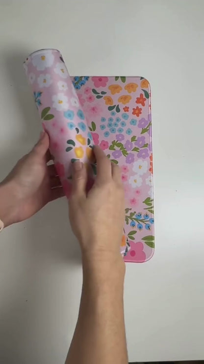Video showing  large floral desk mat with cute colourful print, smooth surface, stitched edges and rubber base for an aesthetic desk setup.