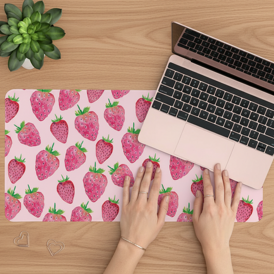 strawberry desk mat featuring watercolour strawberries on a soft pink background in use 