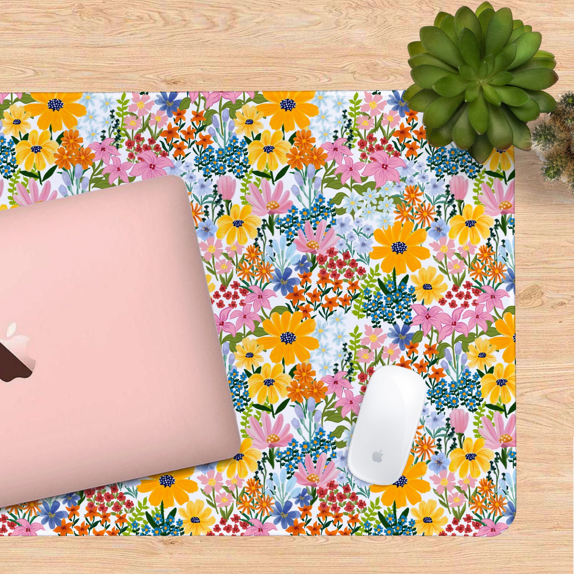 A vibrant floral desk mat featuring hand-drawn flowers in pinks, oranges, and cheerful blues — the ultimate cute desk mat for any mood.