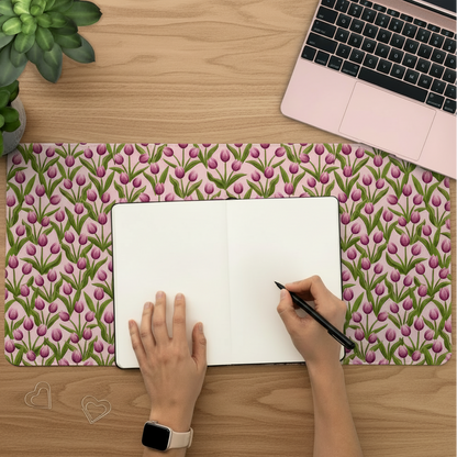Large Tulip desk mat in use featuring pretty florals on a soft pink background 