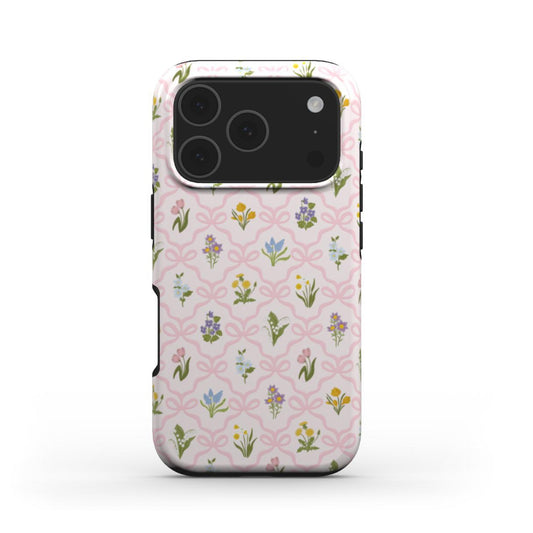 Tough phone case with a vintage wildflower pattern and soft pink bow lattice, combining floral charm with everyday protection.
